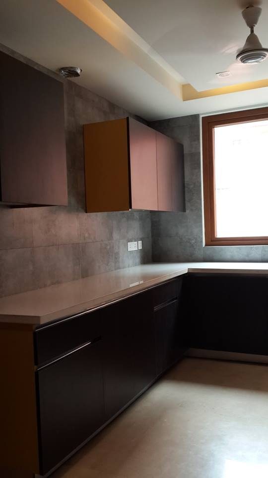 Full galley kitchen view with white gloss cabinets and integrated appliances — GK I Residence